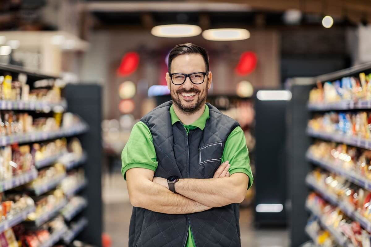 Smiling Man Standing in Grocery Store Aisle in Ann Arbor, Michigan