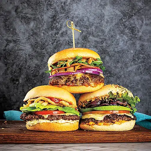 Double smash burgers topped with cheese and fresh vegetables