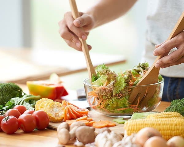 A woman making a healthy salad in Ann Arbor, MI