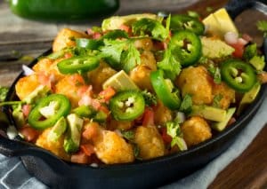 Nachos topped with crispy bites and jalapeno slices in the Southeastern Michigan area 