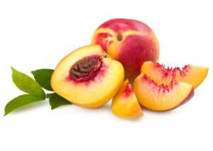 Fresh nectarines with one whole fruit and sliced pieces showing vibrant orange flesh in Ann Arbor