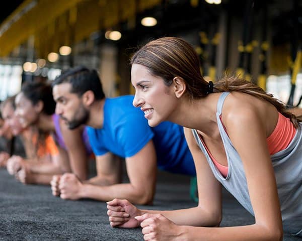 A group of young people doing plank in Ann Arbor, MI